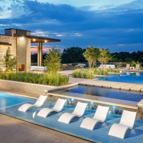 a swimming pool with chairs around it