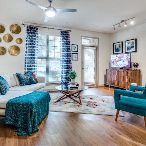 a living room with a couch and chairs