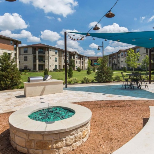 a courtyard with a fountain and buildings